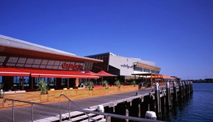 Daryl Jackson's triumvirate of SUPERDURA™ Stainless steel clad sheds at Port Melbourne's Station Pier is the result of some light stepping on a highly visible, vulnerable site